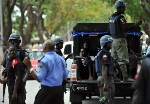 Nigeria police stand guard in Bauchi. A suicide bomber who tried to ram an explosives-packed car into a Nigerian church on Sunday killed a woman and an eight-year-old boy, while wounding dozens more