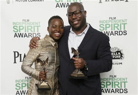 Actress Lupita Nyong'o and director Steve McQueen pose with their awards for "12 Years a Slave" backstage at the 2014 Film Independent Spirit Awards in Santa Monica, California March 1, 2014. REUTERS/Danny Moloshok