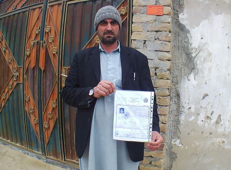 Haji Malik, a shopkeeper who lost his son during the Taliban insurgency in Pakitaka province, poses in Kunduz, Afghanistan