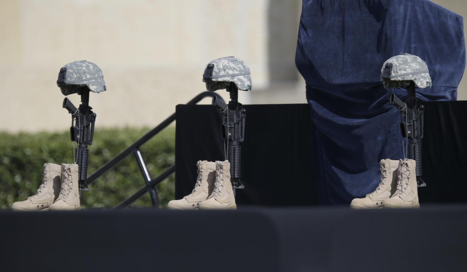 A military memorial for fallen soldiers is displayed prior to a memorial ceremony for shooting victims that President Barack Obama will attend Wednesday, April 9, 2014, in Fort Hood, Texas. Last week's shooting rampage left four dead and more than a dozen injured. (AP Photo/Eric Gay)