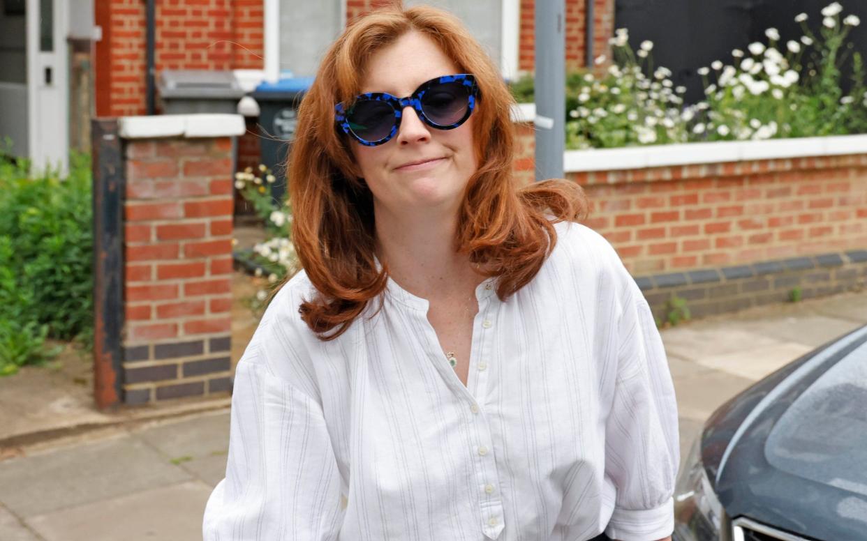 Shades on: Matt Hancock's wife, Martha, was met by a crowd of photographers as she left home on Friday morning - Nigel Howard Media