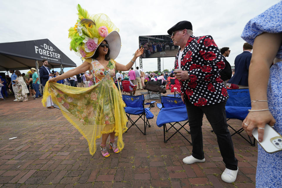 People watch races in the infield as they wait for the 149th running of the Kentucky Derby horse race at Churchill Downs Saturday, May 6, 2023, in Louisville, Ky. (AP Photo/Julio Cortez)