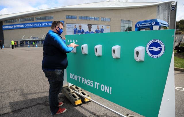 Fans sanitise their hands before the Brighton v Chelsea pre-season friendly on August 29, 2020