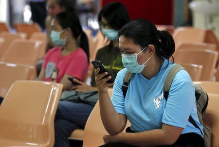 People wear masks to prevent contracting Middle East Respiratory Syndrome (MERS) at the Bamrasnaradura Infectious Diseases Institute in Nonthaburi province, on the outskirts of Bangkok, Thailand, June 19, 2015. REUTERS/Chaiwat Subprasom