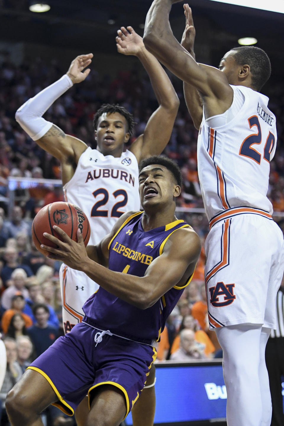 Lipscomb guard Greg Jones (1) looks to shoot while defended by Auburn forward Anfernee McLemore (24) and guard Allen Flanigan (22) during the first half of an NCAA college basketball game Sunday, Dec. 29, 2019, in Auburn, Ala. (AP Photo/Julie Bennett)