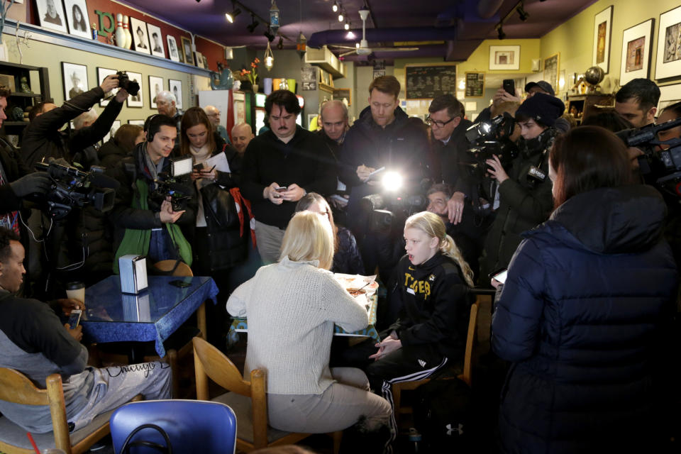 U.S. Kirsten Gillibrand, D-N.Y., with back to camera, sits down for a chat with Jeanette Hopkins, rear, and Chloe McClure, right, at the Pierce Street Coffee Works cafe' in Sioux City, Iowa, Friday, Jan. 18, 2019. Sen. Gillibrand is on a weekend visit to Iowa, after announcing that she is forming an exploratory committee to run for President of the United States in 2020. (AP Photo/Nati Harnik)