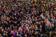 Followers of former Brazilian President Luiz Inacio Lula da Silva, who is running for president again, listen to the partial results after general election polls closed in Rio de Janeiro, Brazil, Sunday, Oct. 2, 2022. (AP Photo/Matias Delacroix)