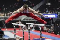 Sam Mikulak of the United States performs on the parallel bars during the American Cup gymnastics competition Saturday, March 7, 2020, in Milwaukee. (AP Photo/Morry Gash)
