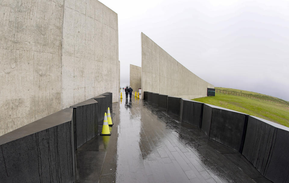 Visitors walk a path at the Flight 93 National Memorial, Saturday, May 8, 2021, in Shanksville, Pa. Serene, stark and seemingly in the middle of nowhere in Pennsylvania, the National Park Service memorial to the people who died on United Airlines Flight 93 is hard to find on a map — as the Sept, 11, 2001, terrorist attack itself slips deeper into the nation's collective memory. (AP Photo/Keith Srakocic)