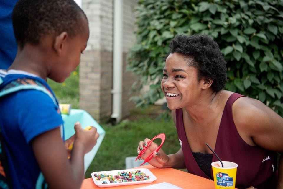 Ashley Allen, co-executive director of Read to Succeed, talks to I’za Resper, 5, while working on his fine motor skills at the Head Start open house July 19, 2023.