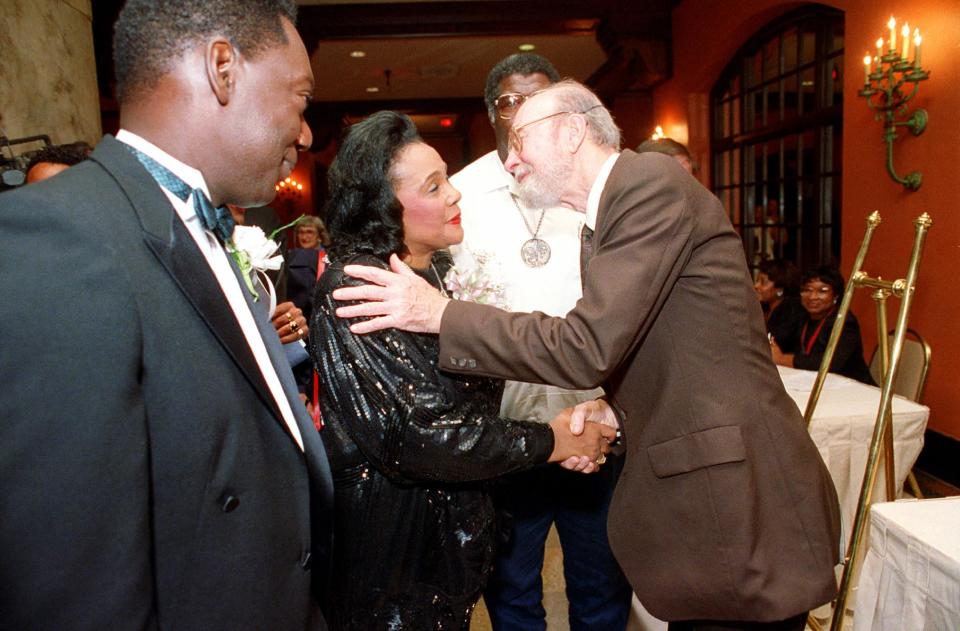 FILE - In this Tuesday night, July 2, 1991 file photo, Coretta Scott King is welcomed by folk singer Pete Seeger as she arrives at a banquet in Memphis, Tenn. during an event leading to the dedication of the National Civil Rights Museum. Seeger died on Monday Jan. 27, 2014, at the age of 94. (AP Photo/Mark Humphrey)