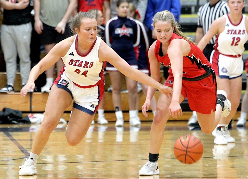 Bedford North Lawrence's Madisyn Bailey (24) goes for a steal against North Knox's Alex McKinley (12). Bailey had 12 points in the game Monday, Nov. 27, 2023.