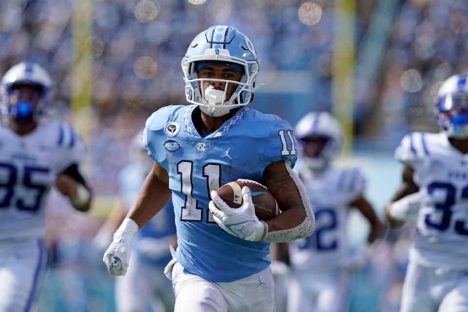 North Carolina receiver Josh Downs races away from Duke defenders for a 63-yard touchdown in October.