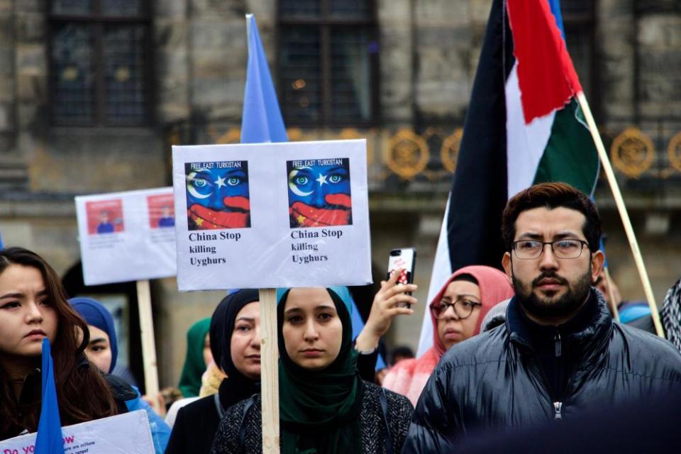 A group of people stage a protest against China’s human rights violations against members of the Turkic Uighur minority