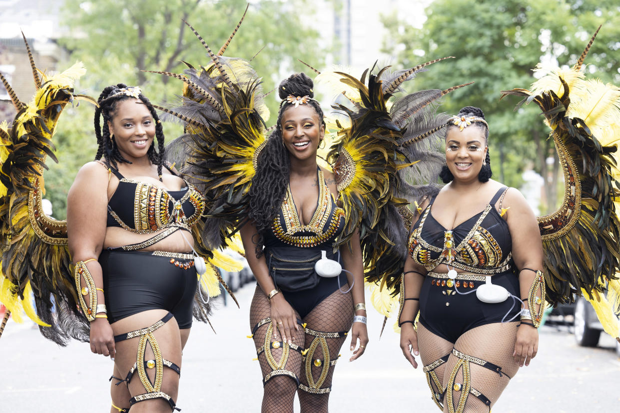 Alexandra Burke appears alongside The Utopia Band wearing Elvie Stride breast pumps under their costumes at Notting Hill Carnival as part of the 'Pumps on Parade' campaign. (PA)

