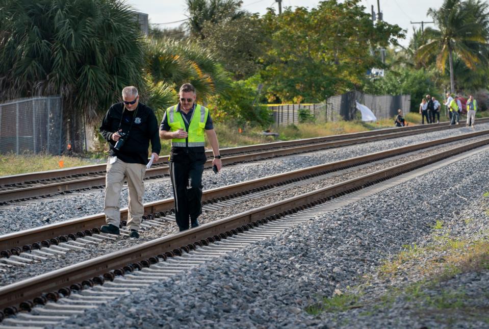 Investigators walk the FEC tracks after a northbound Brightline train struck and killed a person near Northeast 13th Avenue in Boynton Beach, Florida on January 4, 2021.