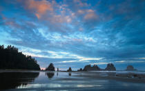 Head to the far northwest corner of the Olympic Peninsula to visit one of Washington States most beautiful beaches. Bring your camping geargetting to Shi Shi requires a trek through the fir-filled forest to the cliff edge that drops into the Pacific Ocean. Hike down the rocky trail to the unspoiled beach lined by tide pools and driftwood stands. Set up camp on the beach to watch the sunset behind the stunning sea stacks and rocky arches for a dramatic Pacific sunset.