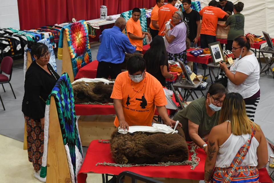 Rosebud Sioux tribal members gather to welcome home the remains of nine children, wrapped in bison skin, on Friday, July 16, 2021 at the Student Multicultural Center at Sinte Gleska University on the Rosebud Reservation.