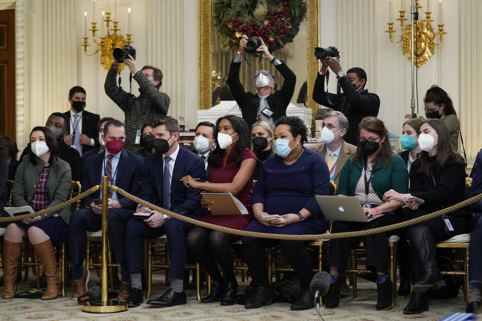 FILE - Members of the White House press corps listen as President Joe Biden speaks about the COVID-19 response and vaccinations Dec. 21, 2021, in the State Dining Room of the White House in Washington. As President Joe Biden wraps up his first year in the White House, he has held fewer news conferences than any of his five immediate predecessors at the same point in their presidencies, and has taken part in fewer media interviews than any of his recent predecessors. That's according to new research from Towson University professor emerita Martha Joynt Kumar. (AP Photo/Patrick Semansky, File)