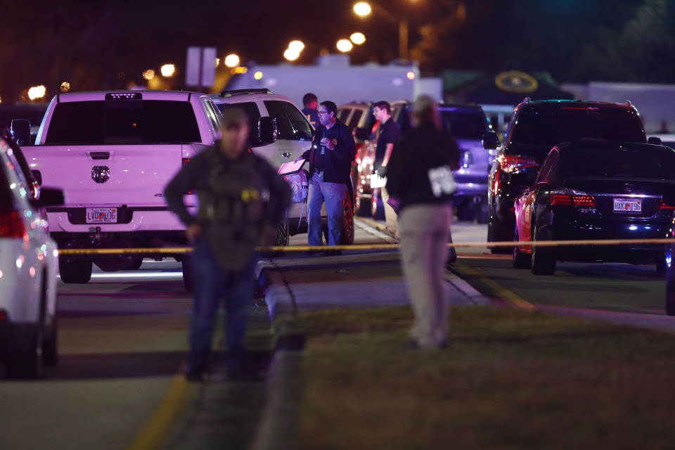 Authorities investigate the scene of a shooting Thursday, Dec. 5, 2019, in Miramar, Fla. Four people, including a UPS driver, were killed Thursday after robbers stole the driver’s truck and led police on a chase that ended in gunfire at a busy Florida intersection during rush hour, the FBI said. (AP Photo/Brynn Anderson)