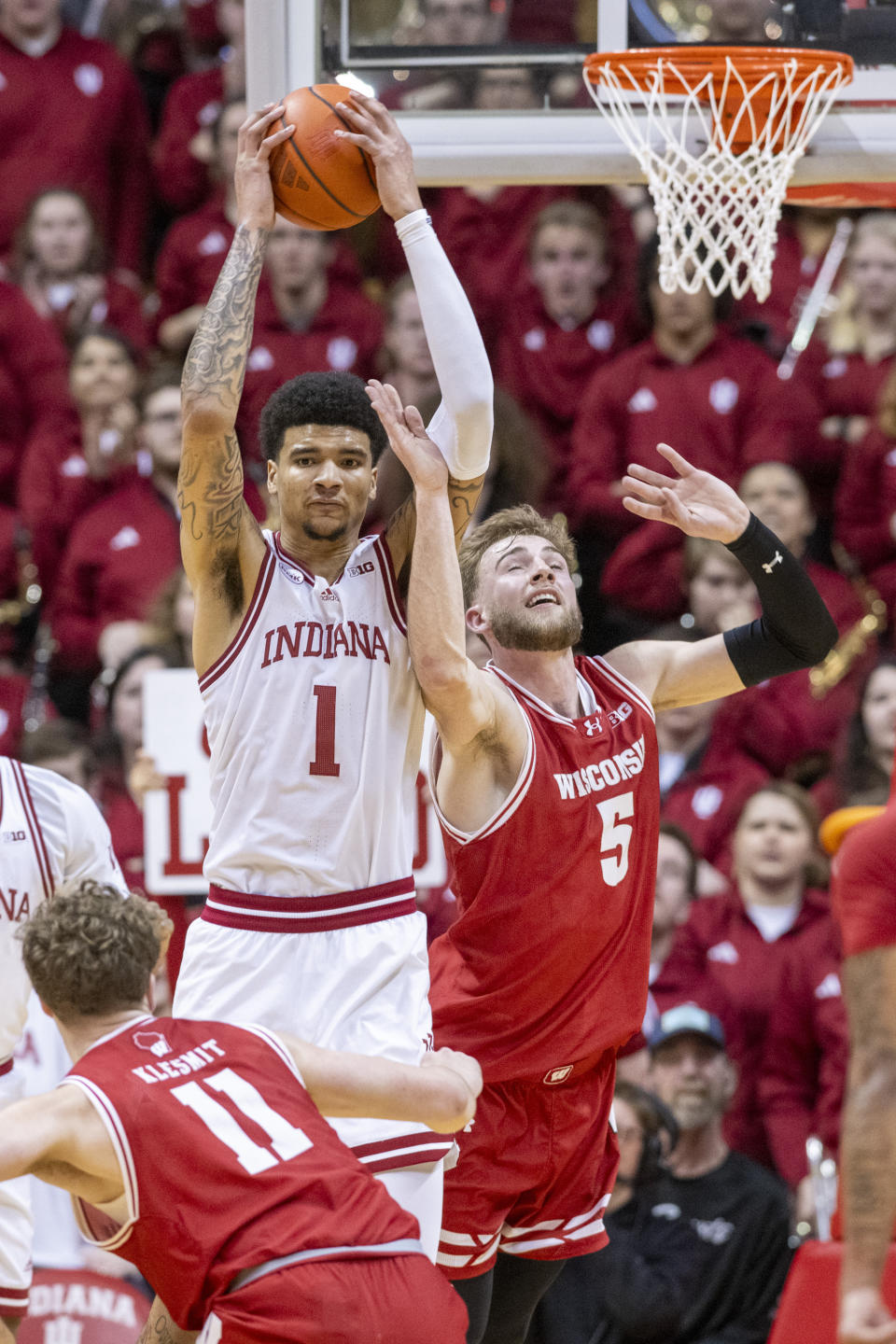 Indiana center Kel'el Ware (1) controls a rebound against Wisconsin forward Tyler Wahl (5) during the second half of an NCAA college basketball game, Tuesday, Feb. 27, 2024, in Bloomington, Ind. (AP Photo/Doug McSchooler)