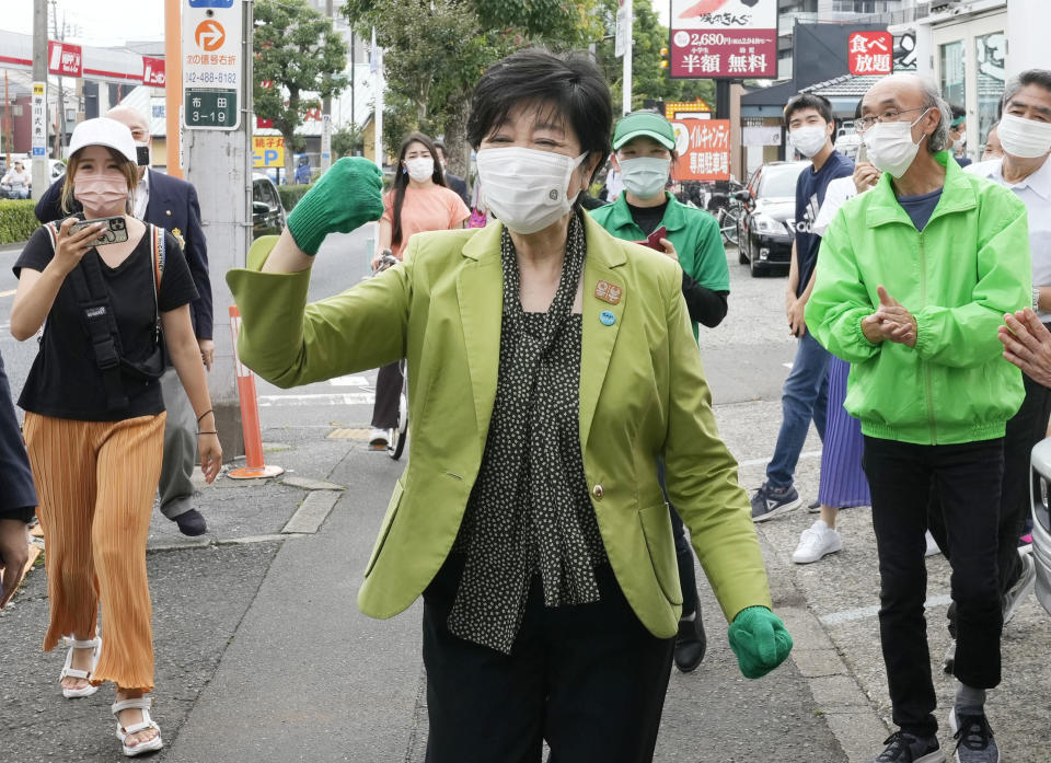 Tokyo Gov. Yuriko Koike shows up to support a candidate from her Tomin First party on the Tokyo metropolitan assembly election day in Tokyo on Sunday, July 4, 2021. Voters in Japan's capital are electing the Tokyo city assembly amid worries about health risks during the Olympics, opening in three weeks, as coronavirus cases continue to rise. (Kyodo News via AP)