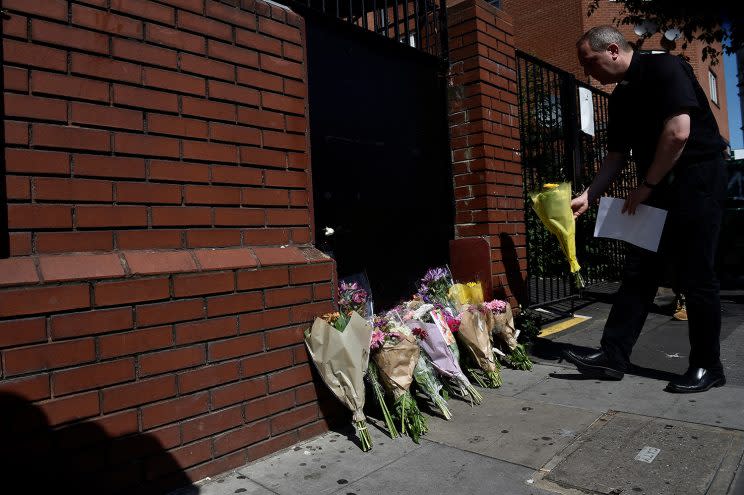 A priest leaves flowers near the scene of an attack where a van was driven at muslims outside a mosque in Finsbury Park in North London, Britain, June 19, 2017. (Photo: Hannah McKay/Reuters)