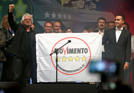 5-Star movement founder Beppe Grillo (L) and Luigi Di Maio hold the banner of the movement during a gathering in Rimini, Italy, September 23, 2017. REUTERS/Max Rossi