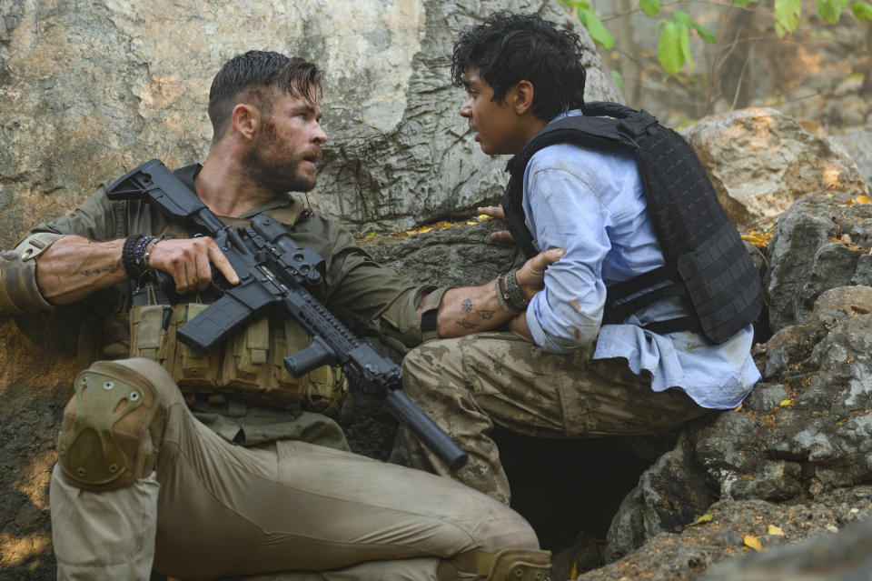 This image released by Netflix shows Chris Hemsworth, left, and Rudhraksh Jaiswal in a scene from "Extraction," premiering this week on Netflix. (Jasin Boland/Netflix via AP)