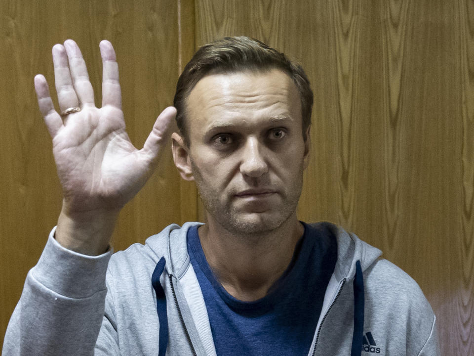 Russian opposition leader Alexei Navalny gestures in a court room in Moscow, Russia, Monday, Aug. 27, 2018. A court in Moscow has sentenced Russian opposition leader Alexei Navalny to a month in jail for an unsanctioned protest rally. Navalny’s arrest outside his home on Saturday came as a surprise since police detained him over a protest rally held in January. (AP Photo/Pavel Golovkin)