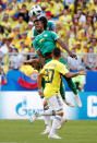 <p>Senegal’s Keita Balde heads the ball away as Juan Quintero watches on </p>