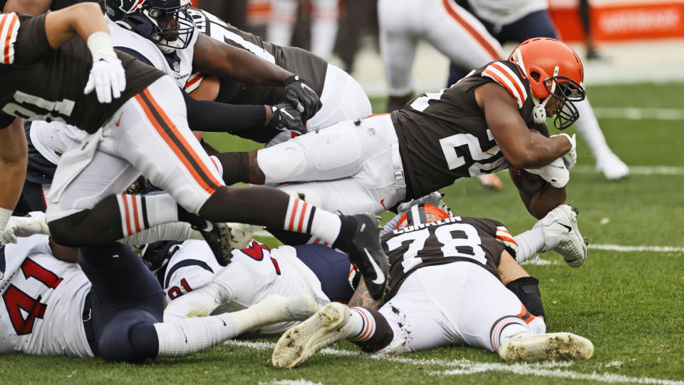 Cleveland Browns running back Nick Chubb dives over players during the first half of an NFL football game against the Houston Texans, Sunday, Nov. 15, 2020, in Cleveland. (AP Photo/Ron Schwane)