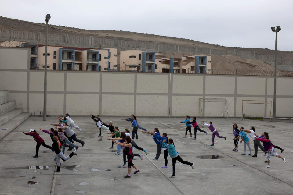 In this Aug. 27, 2013 photo, foreign female inmates exercise at Piedras Gordas prison on the outskirts of Lima, Peru. In Peru, drug mule sentences range that minimum to 15 years. But inmates must stay in the country, even if paroled, until their full sentence ends and they’ve paid their fines. (AP Photo/Martin Mejia)