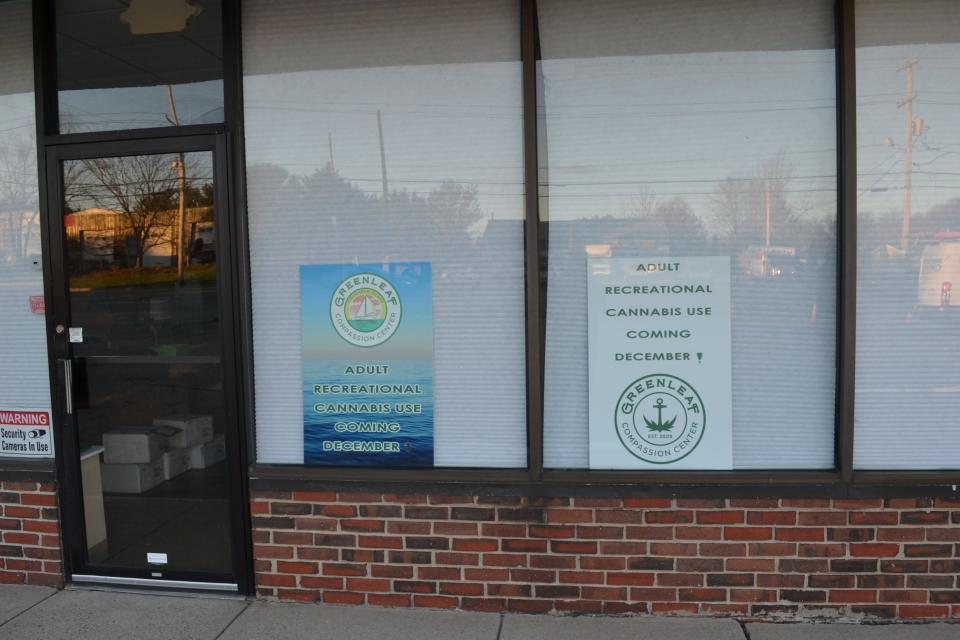 Posters in the window signal the beginning of recreational marijuana sales at Greenleaf Compassion Center in Portsmouth.