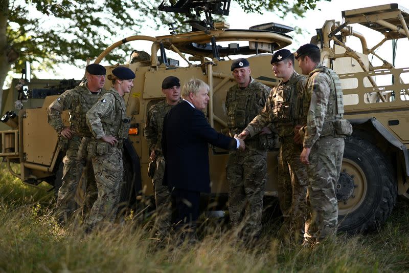 Britain's Prime Minister Boris Johnson meets with military personnel on Salisbury plain training area near Salisbury