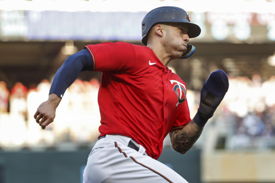 Minnesota Twins' Carlos Correa tries to score from second base on a single by Jose Miranda against the Baltimore Orioles during the first inning of a baseball game Friday, July 1, 2022, in Minneapolis. Correa was thrown out at home. (AP Photo/Bruce Kluckhohn)