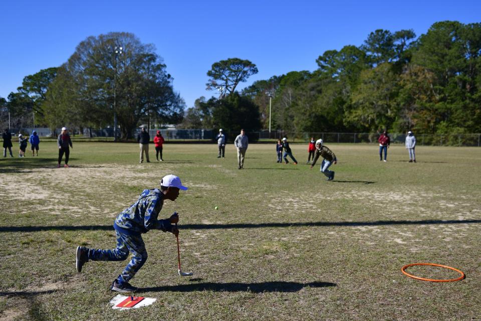 Ali Brown-Campbell, 10, runs to first base while playing a game of Golf Baseball on Jan. 17 at the Clanzel Brown Community Center.