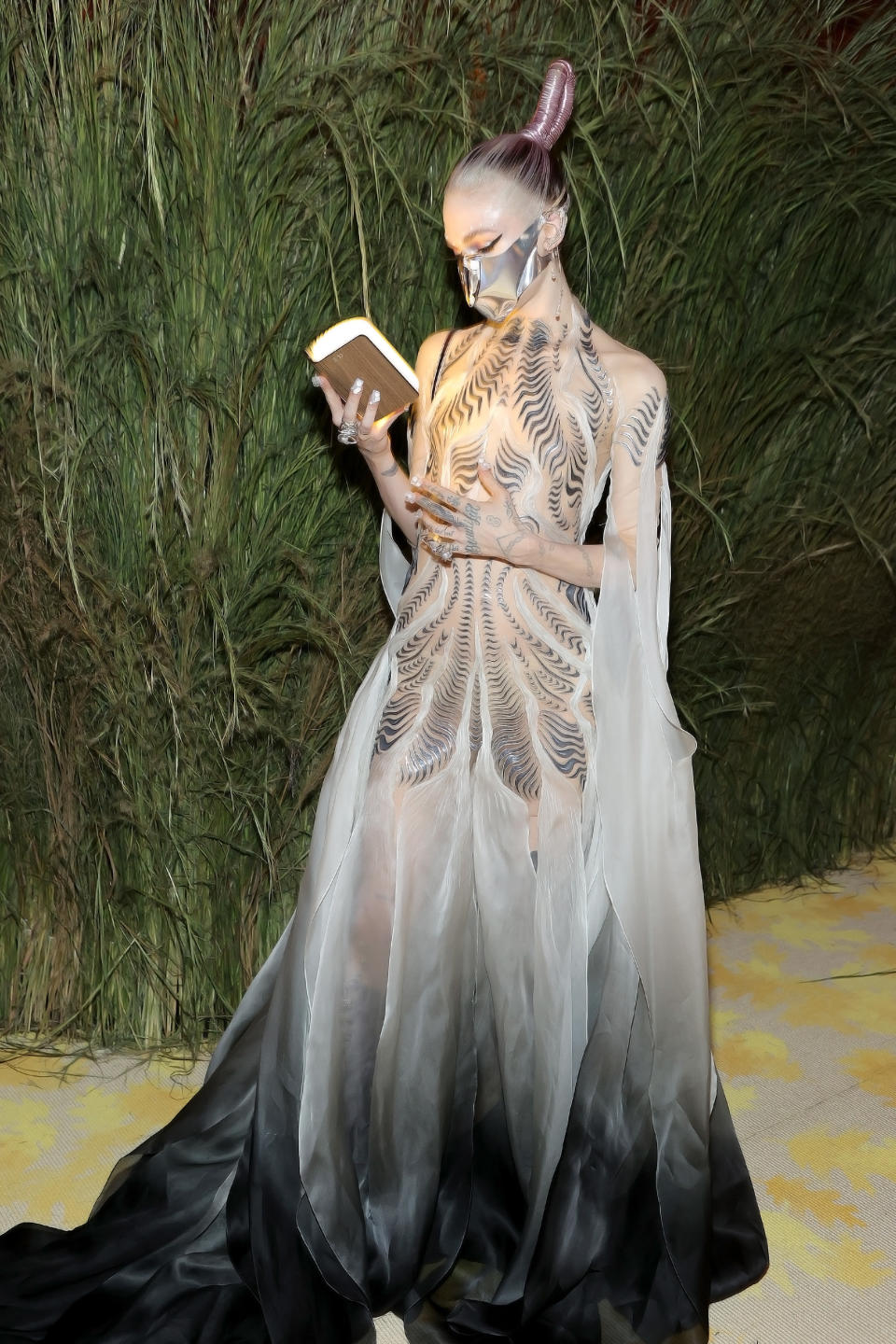 Grimes reads from the book, which is glowing with light