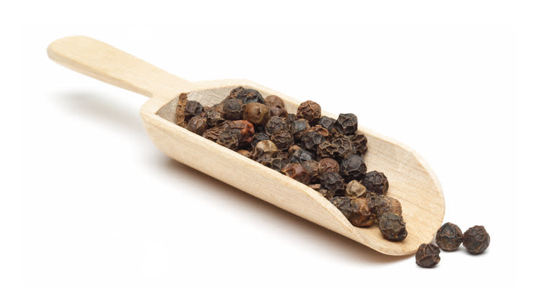 Wooden spoon with peppercorns