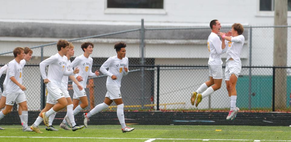 St. Xavier's Beckham Murrow celebrates with Liam Eisner after Murrow scored against Lafayette on Saturday.