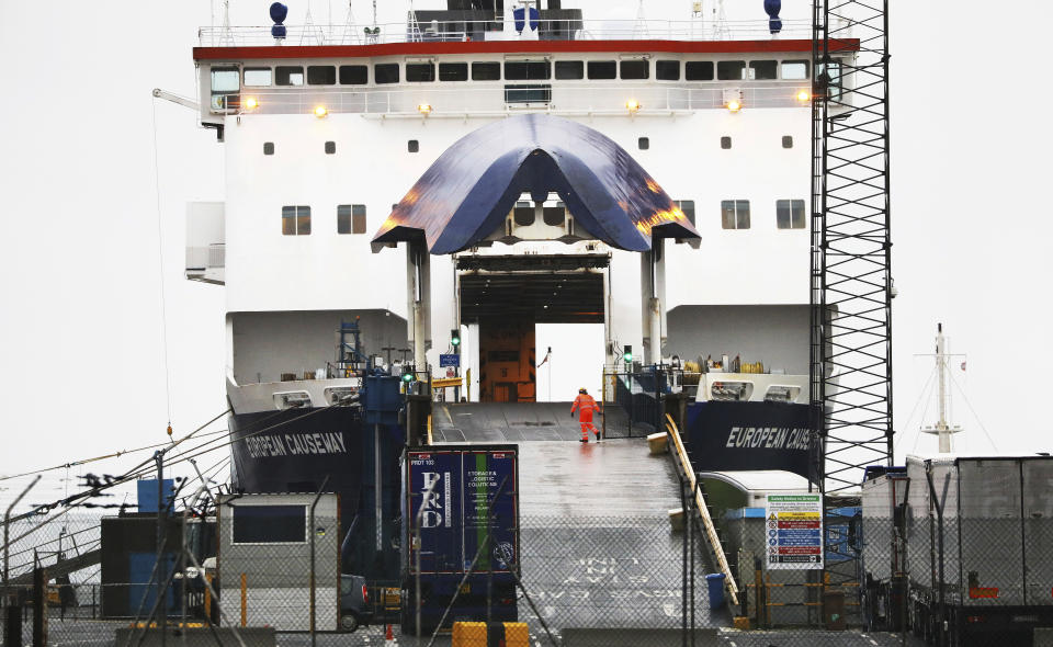 A P&O worker closes the gate on the European Causeway ferry from Scotland in the port of Larne, Northern Ireland, Tuesday, Feb. 2, 2021. Authorities in Northern Ireland have suspended post-Brexit border checks on animal products and withdrawn workers after threats against border staff.(AP Photo/Peter Morrison)