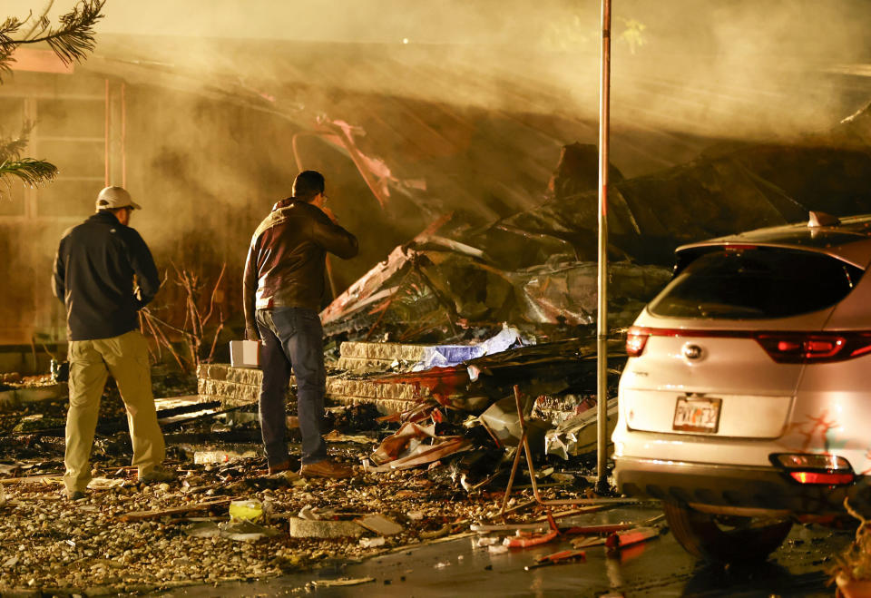 Investigators look at the burned out remains of a mobile home after a plane crash Thursday, Feb. 1, 2024 in Clearwater, Fla. Fire officials say a small plane has crashed into a home at a Florida mobile home park, killing several people aboard the plane and in the home. (Chris Urso/Tampa Bay Times via AP)