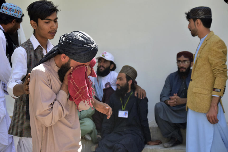 People mourn for their relative, who was killed in a bomb explosion, at a hospital, in Quetta, Pakistan, Friday, Sept. 29, 2023. A powerful bomb exploded at a rally celebrating the birthday of Islam's Prophet Muhammad in southwest Pakistan on Friday, killing multiple people and wounding dozens of others, police and a government official said. (AP Photo/Arshad Butt)