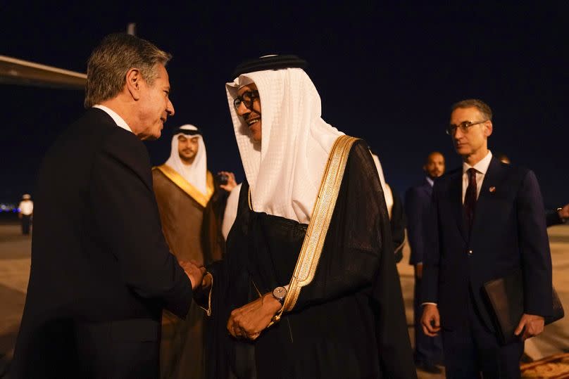US Secretary of State Antony Blinken talks with Bahrain's Foreign Minister Abdullatif bin Rashid al-Zayani as he arrives in Manama, 13 October 2023