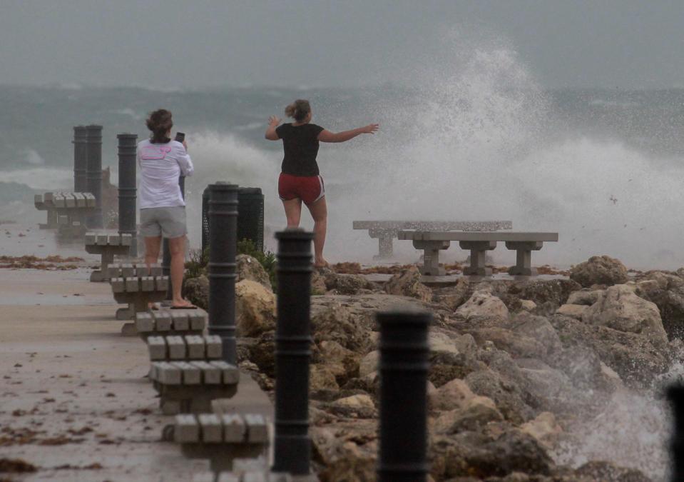 Wind and waves greet spectators while they walk the Fort Pierce Jetty as Potential Tropical Cyclone One moves over the area Saturday, June 4, 2022.