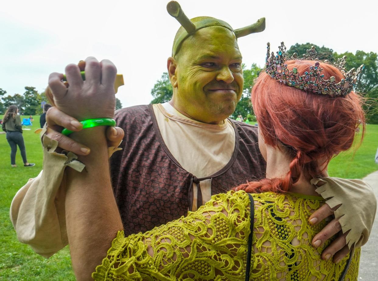 James Hurst (Shrek) and Kathy Hurst (Fiona) dance during Shrekfest Saturday, Sept. 3, 2022, located at Humboldt Park in Milwaukee. 'Shrek is love, Shrek is life,' J.Hurst said. Kids in his neighborhood use to call him Shrek and he then started dressing as him ever since.