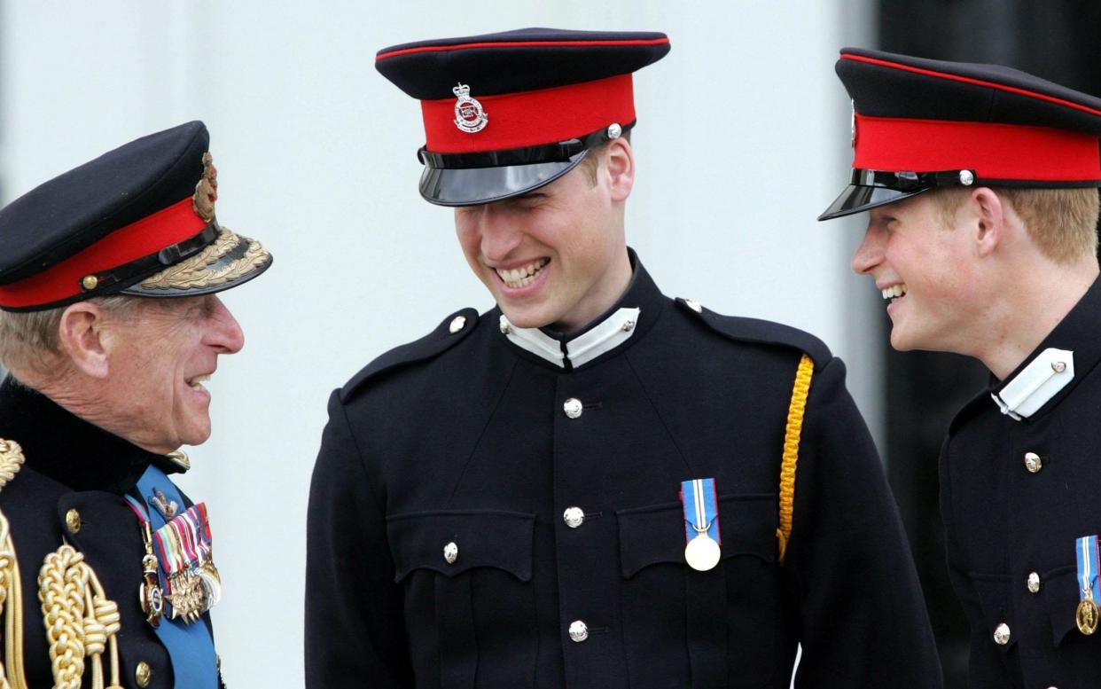 The Duke of Edinburgh speaks to Prince William and Prince Harry at Sandhurst Royal Military Academy in 2006 - PA