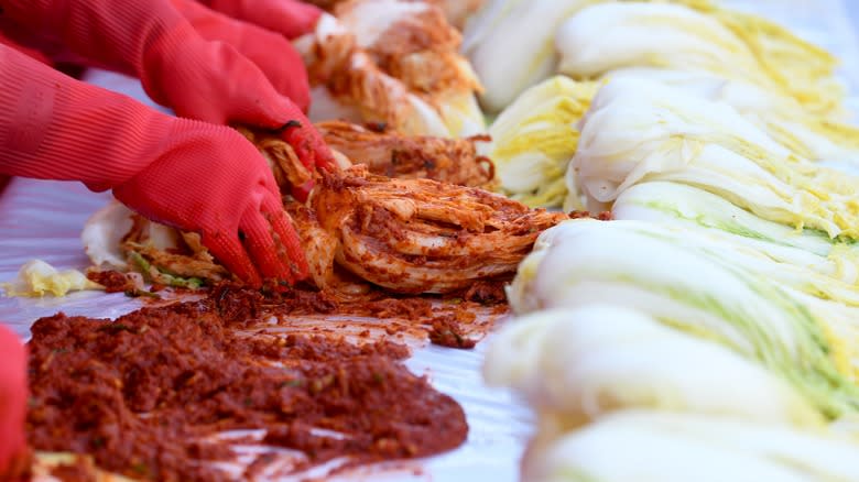 hands rubbing paste into cabbage