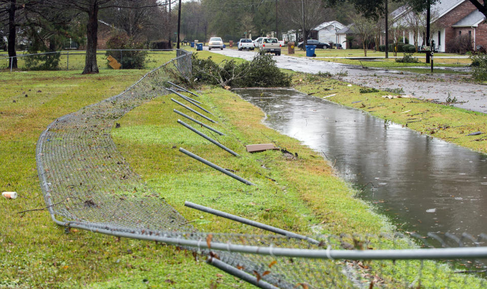 Wind damage to a fence, possibly caused by a small tornado, is pictured on La Butte Street following heavy rain and thunderstorms on Thursday, Dec. 27, 2018, near Carencro, La. No injuries were reported. (Leslie Westbrook/The Advocate via AP)