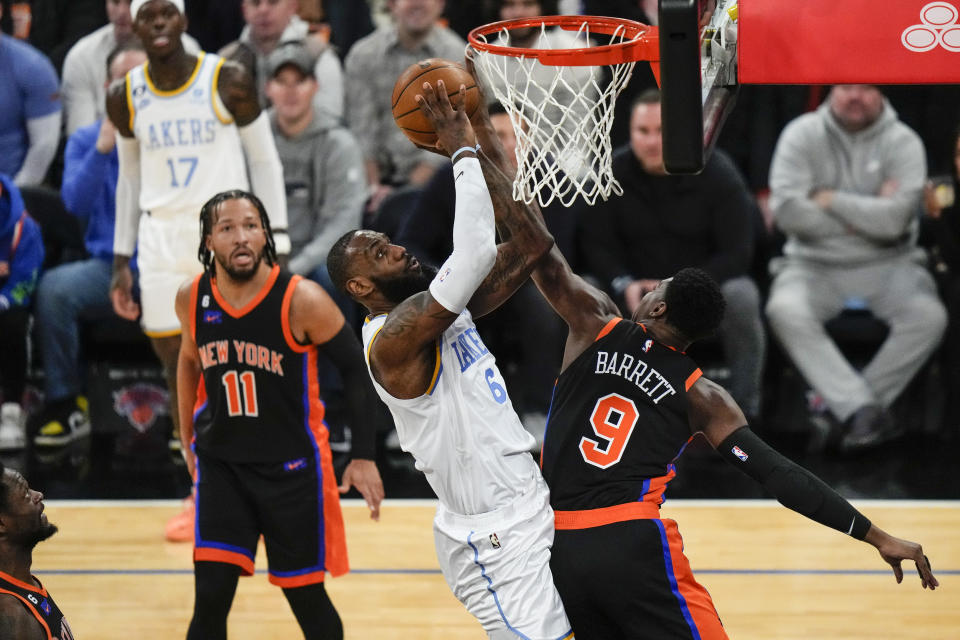 Los Angeles Lakers' LeBron James (6) shoots over New York Knicks' RJ Barrett (9) as Jalen Brunson (11) watches during the first half of an NBA basketball game Tuesday, Jan. 31, 2023, in New York. (AP Photo/Frank Franklin II)